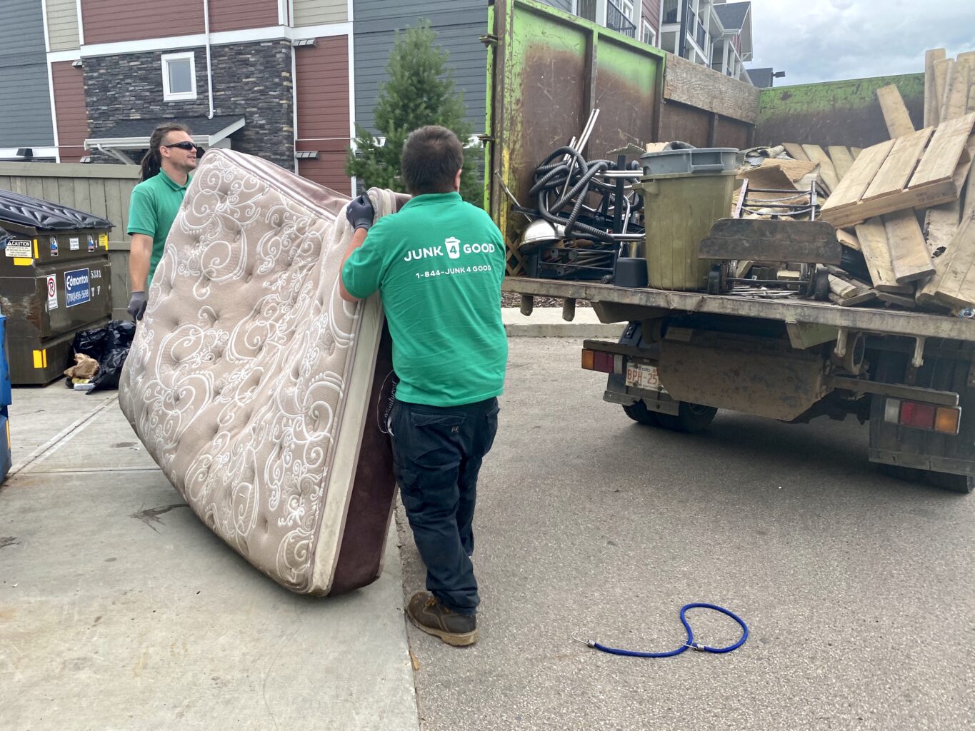 Junk 4 Good's team load up a mattress from a property manager's site in Edmonton